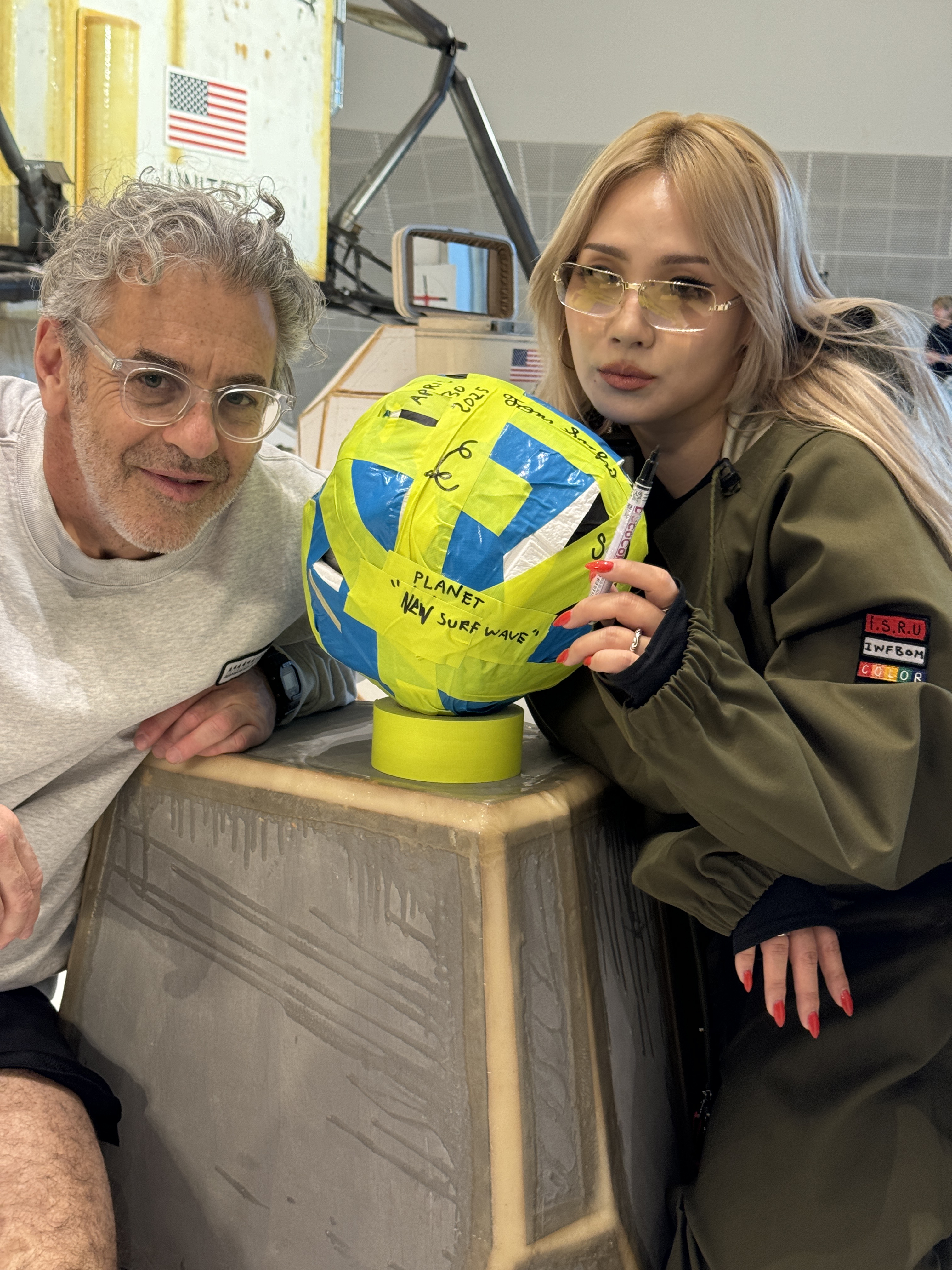 Tom Sachs poses with a medicine ball with CL